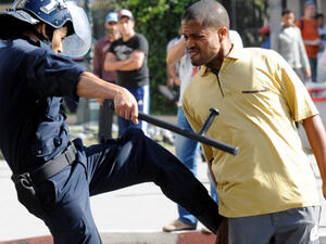 A police officer kicks a demonstrator during a protest in Rabat, Morocco. (AFP/File) A police officer kicks a demonstrator during a protest in Rabat, Morocco. (AFP/File)