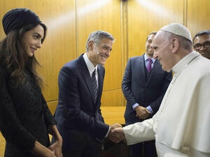 Pope Francis shaking hands with US actor George Clooney and his wife Amal Clooney prior a meeting with the participants of the Sixth World Congress of Pontifical Foundation Scholas Occurrentes. (AFP)
