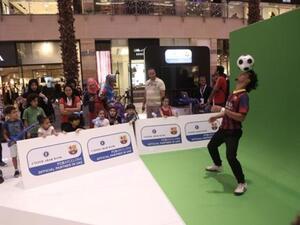 Free Styler wows the visitors by performing soccer tricks at the UAB stand organised for the bank's alliance with FC Barcelona