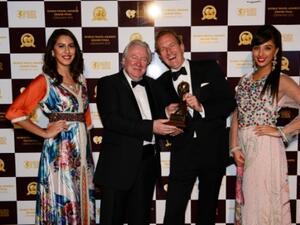 Alexander Schneider (right) pictured with awards hostesses and Graham Cooke – President and Founder of World Group (left)