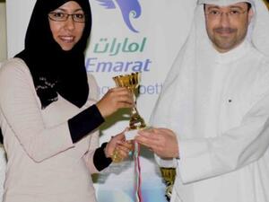 Abdulla Hassan Al Noman honoring one of the winners 