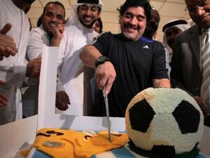 Diego Maradona cutting his birthday cake