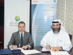 Adnan Chilwan, CEO, DIB and Sami Abdullah Gargash, CEO, MRHE, sign the agreement