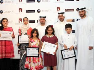 EIB officials with the winners of the card design competition