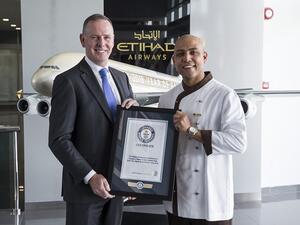 Tony Douglas, Group Chief Executive Officer, Etihad Aviation Group, congratulates Etihad Airways Inflight Chef, Sanjay Thakur.