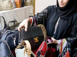 Eman Al Mansoori, Marketing Manager at Dubai Ladies Club with a selection of designer bags in 2010