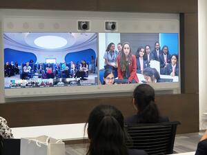 Girls engaging with Cisco Execs using Cisco's Telepresence technology.