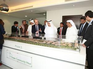 Khalid Bin Kalban and other officials viewing the model of Green Community West DIP-Phase III