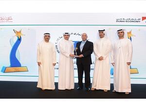 Mr. Sanjay Malhotra, Chief of Consumer Banking, DIB, receiving the Best 