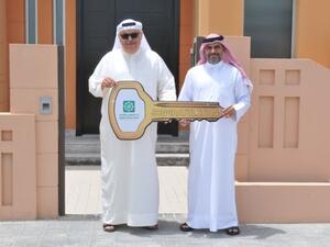 Mr. Hasan AbuAli, Senior Branches Manager-KFH-Bahrain handing Mr. Hasan AlNaser the villa’s key.