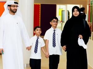 Parents with their children who received the scholarship.