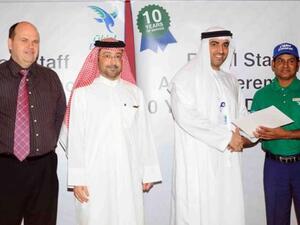 Dr. Rahma honors a staff member in the presence of Abdulla Al Noman, and Darren Smith