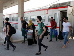 Iraqi passengers disembark from a train coming from Baghdad as it arrives in the city of Fallujah in Anbar province, about 70 kilometers west of the capital. (AFP)