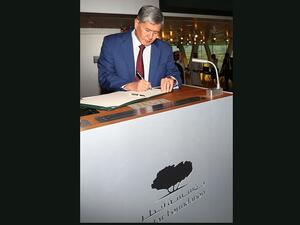 الرئيس القرغيزي، ألماز بيك أتامباييف، يوَّقِع في سجل الزوار الخاص بمؤسسة قطر