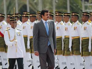 Qatar's Emir Sheikh Tamim bin Hamad Al Thani inspects an honor guard during a welcome ceremony in Kuala Lumpur, Malaysia, on October 16, 2017. (Vincent Thian/ AP)