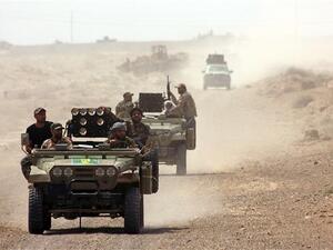 Iraqi forces drive through the Anbar province ahead of an operation to recapture the city of Ramadi. (AFP/Ahmed al-Rubaye)
