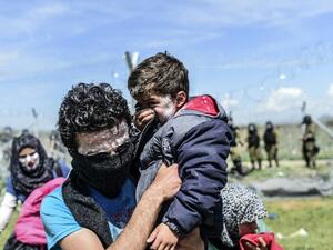 A family with toothpaste smeared over their faces as a protection against teargas, moves to safety as refugees and migrants clash with Macedonian police during a protest to reopen the border near their makeshift camp in the northern Greek border village of Idomeni, on April 10, 2016. (AFP/Bulent Kilic) A family with toothpaste smeared over their faces as a protection against teargas, moves to safety as refugees and migrants clash with Macedonian police during a protest to reopen the border near their makeshift camp in the northern Greek border village of Idomeni, on April 10, 2016. (AFP/Bulent Kilic)