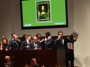 Christie's employees take bids for Leonardo da Vinci's "Salvator Mundi" at Christie's New York (AFP/File Photo)	