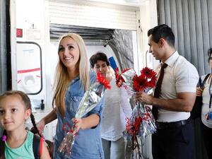 Turkish airport staff welcome Russian tourists at Antalya airport on July 9, 2016, a few months after the two countries clashed over a Russian warplane crash in Syria. (AFP/File)