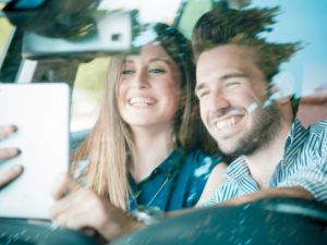 This selfie while driving could cost the couple a hefty fine and the seizure of their car! (Shutterstock)