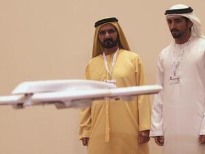 Sheikh Hamdan bin Mohammed bin Rashid al Maktoum together with his father Sheikh Mohammed bin Rashid al Maktoum (left) visiting the "Virtual Future" exhibition in Dubai on 9 February 2014. (AFP/File)