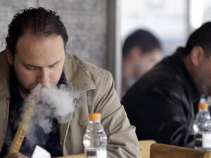 Men smoke water pipes, known as arghileh, at a cafe in Amman, Jordan.  (AFP/Khalil Mazraawi)