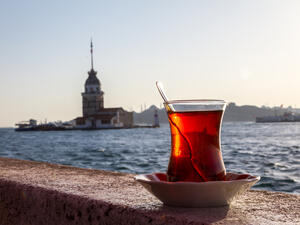 A cup of Turkish tea on the background of the Maiden Tower. (Shutterstock)