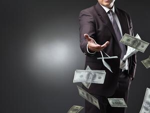 The video showed one person throwing Dh1,000 bank notes under his feet while being encouraged by the second. (Shutterstock)