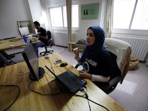 Palestinians work at the office of Red Crow, a startup that monitors security developments and sends real-time alerts to clients. (AFP/Abbas Momani)