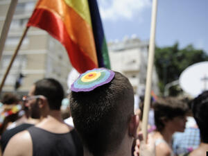 A man wears a rainbow kippah at Tel Aviv's 2013 gay pride parade.  (AFP/David Buimovitch)