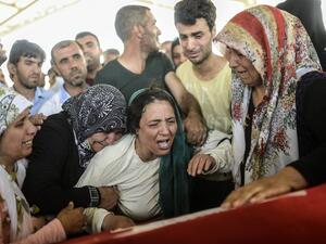 Family members mourn at the coffin of a man killed by a Daesh-linked suicide bombing in Suruç, Turkey last month.  (AFP/File)