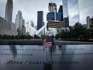 A US flag is placed on the 9/11 memorial before the ceremony to commemorate the 14th Anniversary of the terrorist attacks on Sept. 11, 2015 in New York. (AFP/Kena Betancur)