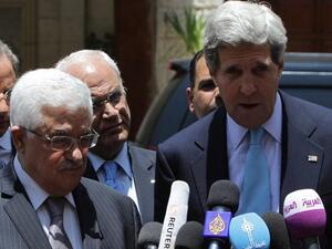 US Secretary of State John Kerry speaks to the press with Palestinian president Mahmoud Abbas following their meeting in the West Bank city of Ramallah (Abbas Momani / AFP)
