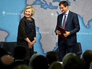 Former US secretary of state Hillary Clinton and director of Chatham House Robin Niblett (R) arrive for a discussuion session at Chatham House in central London on October 11, 2013. (Image credit: AFP)