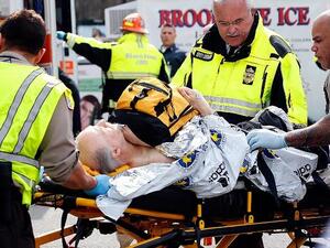 A man is loaded into an ambulance after being injured in the Boston Marathon bomb attacks (AFP/ Jim Rogash)
