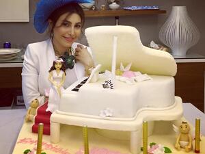 Yara poses with her fabulous piano cake. (Facebook)
