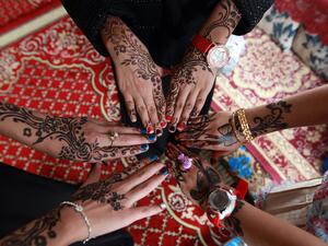 Yemeni girls show off their henna-decorated hands for Eid al-Fitr, the festival marking the end of Ramadan, July 29 2014.  (AFP/File)