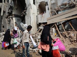 Yemenis carry belongings they recovered from the rubble of buildings destroyed during Saudi-led air strikes the previous day, on September 22, 2016 in the rebel-held Yemeni port city of Hodeida. (AFP/Stringer)