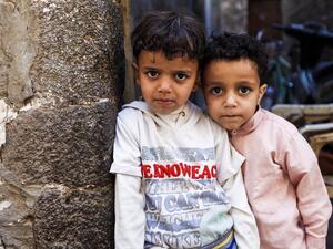 Two Yemeni children pose for a picture in a market in the capital, Sanaa, on January 24, 2017. (AFP/Mohammed Huwais)