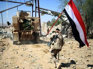 A Yemeni tribesman from the Popular Resistance Committees, loyal to Yemen's Saudi-backed President, holds a Yemeni flag west of Marib city, as the fight against Houthi rebels continues, on Feb. 11, 2016. (AFP/Abdullah al-Qadry)