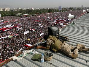 A sniper from the Yemeni security forces watches over during a gathering in support of the Huthi-led parliament, in the capital Sanaa on August 20, 2016. (AFP/Mohammed Huwais)
