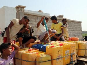 Yemeni children fill empty jerrycans with water from a donated source amid ongoing widespread disruption of water supplies in an impoverished coastal village on the outskirts of the Yemeni port city of Hodeidah, on October 18, 2016. (AFP/Stringer)