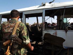YEMEN, SANAA : Yemeni security forces inspect a damaged military bus following a bomb blast in Sanaa on August 25, 2013. AFP PHOTO/ MOHAMMED HUWAIS