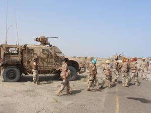 Yemeni pro-government fighters walk in front of a military vehicle, before heading to Zinjibar, the capital of Yemen's southern province of Abyan, to launch an offensive to recapture the town from al-Qaeda on August 14, 2016. (AFP/Saleh al-Obeidi)