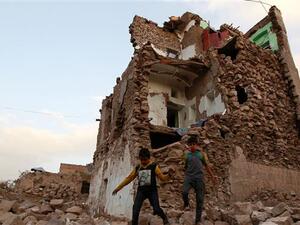 This March 23, 2016 file photo shows Yemeni children walking on stones in front of buildings that were damaged by Saudi airstrikes in the capital Sana’a. (AFP/File) This March 23, 2016 file photo shows Yemeni children walking on stones in front of buildings that were damaged by Saudi airstrikes in the capital Sana’a. (AFP/File)