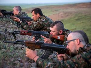 Foreign fighters who joined the Kurdish People's Protection Units (YPG) to fight in their ranks against jihadists and Islamist rebels in northeastern Syria take part in a training session on April 29, 2015 in the south-west Syrian region of Ras al-Ain, close to the Turkish border. (AFP/Uygar Onder Simsek)