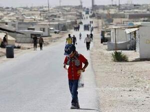 A young Syrian refugee walks along a road in Jordan's crowded Zaatari camp. (AFP/File)