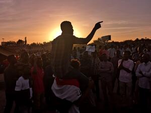 Sudanese protesters rally in the area of the military headquarters in the capital Khartoum at sunset  (AFP)
