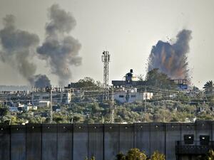 A picture taken from the southern Israeli village of Netiv Haasara shows an explosion and smoke fumes caused by an Israeli airstike across the border in the Gaza Strip (AFP)
