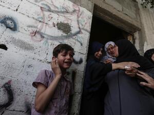 Relatives mourn during the funeral of five Palestinians, who were killed in Israeli strikes (AFP)